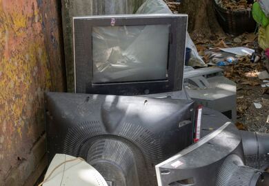 Dumpster with pile of televisions and VCRs being junked in Mokena