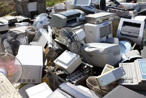 Large pile of old computers and printers to be picked up by removal service