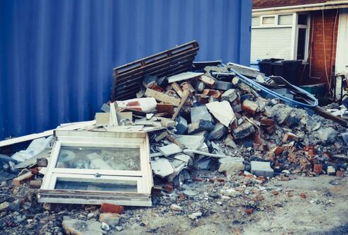 pile of rubble, concrete, wood, and windows from home demolition service